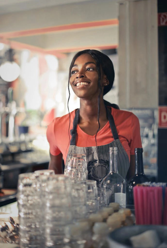 Alcohol Server Woman in Orange T-Shirt Smiling
